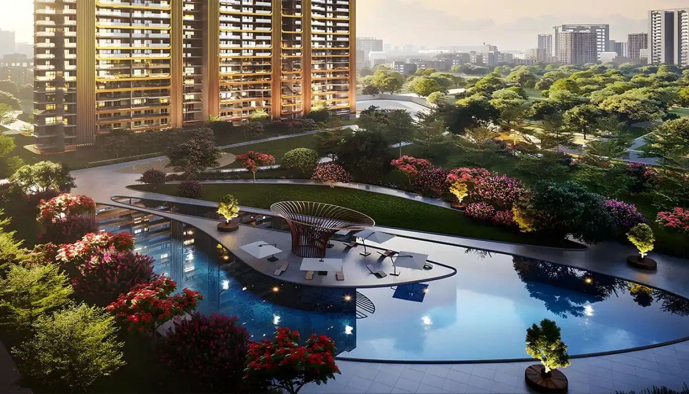 M3M Forestia West club pool and landscaped gardens at twilight with flowering trees